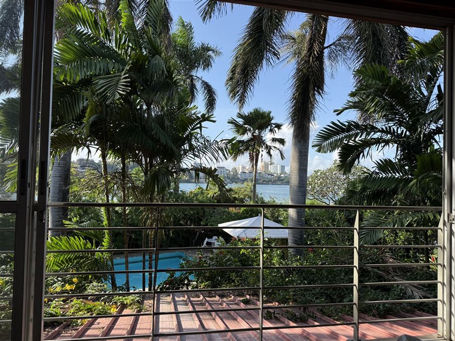 View from a balcony over the pool to the creek