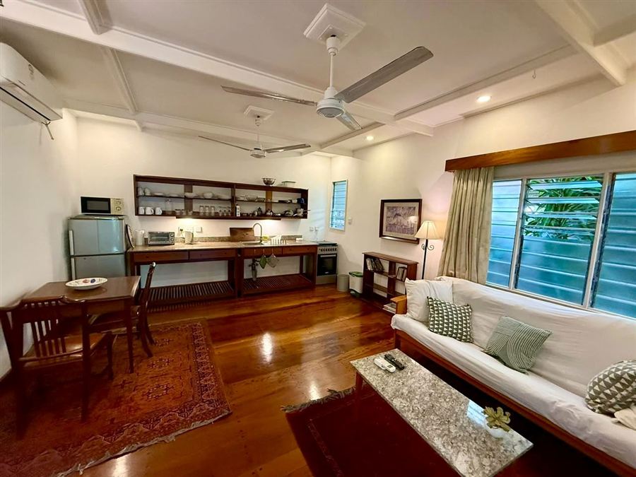 Living room with a long desk and louvred windows