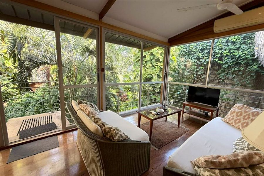Glass-walled living room up among the trees