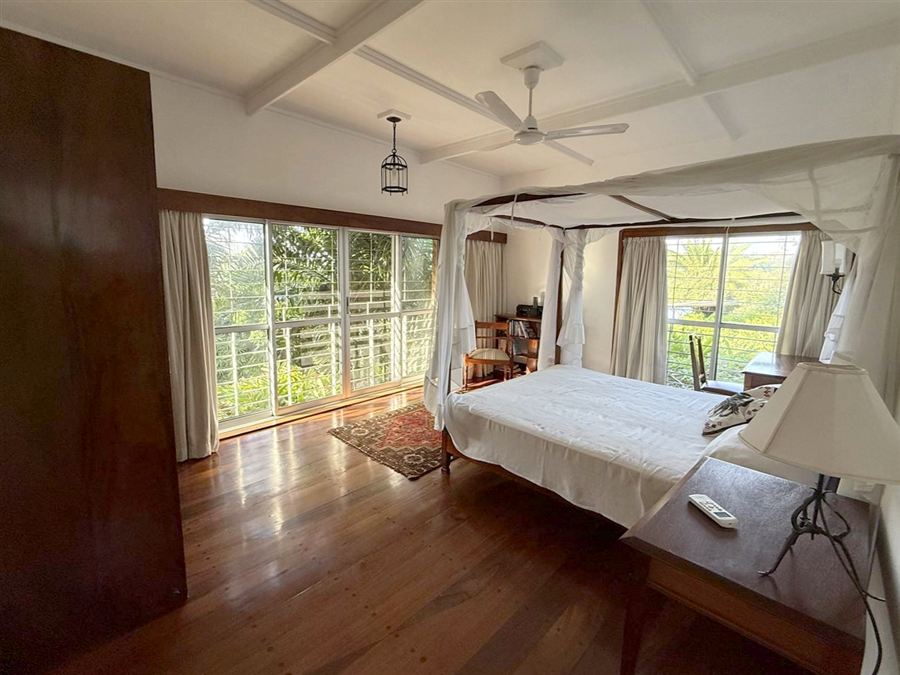 Bedroom with a four-poster bed and garden view
