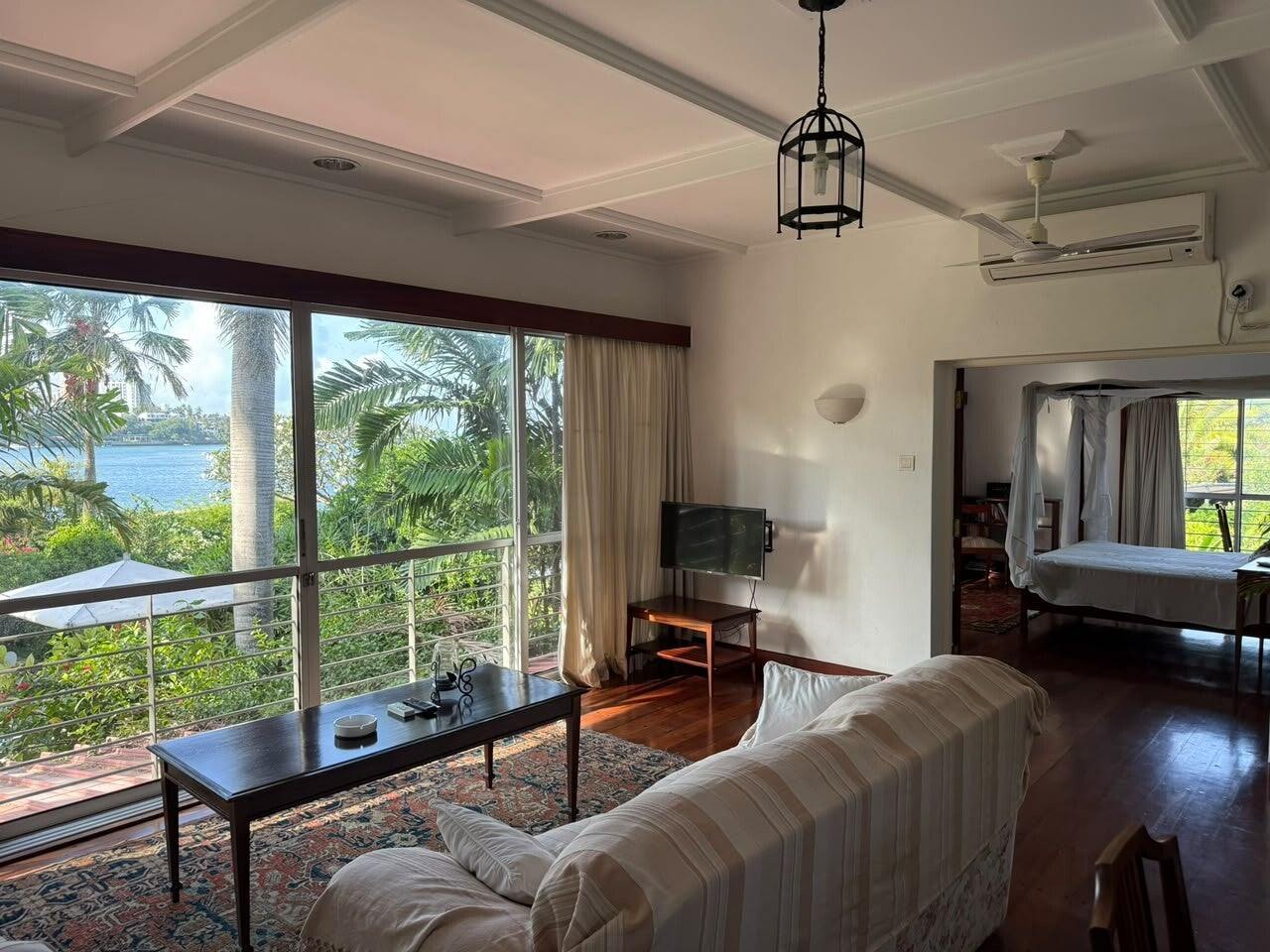 Lounge with tall windows onto the water