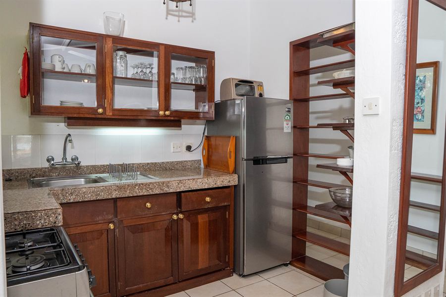 Kitchen with timber cabinets, a gas hob and a fridge