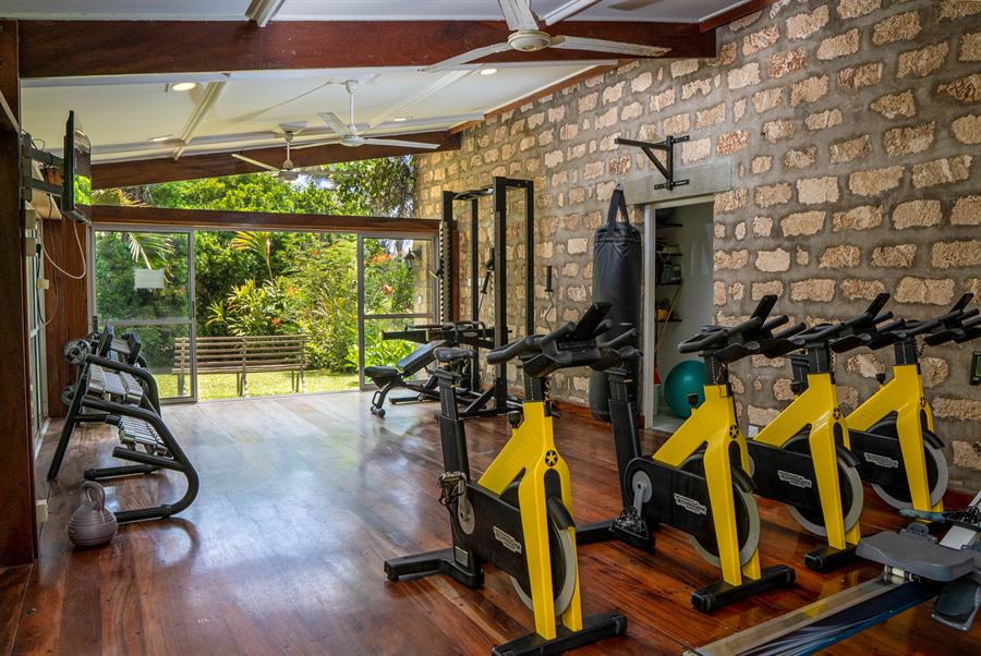 Residents' gym with spin bikes and a punch bag, open to the garden