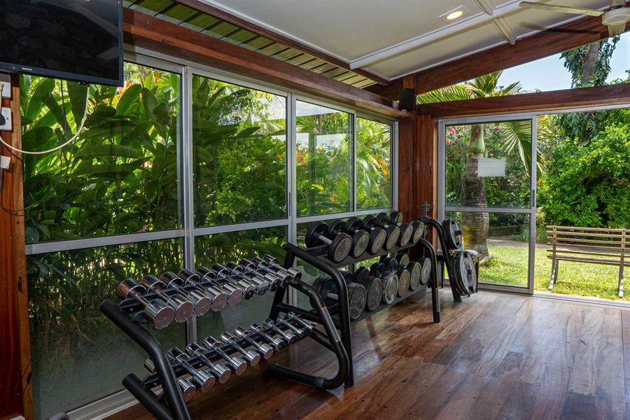Dumbbell racks by the windows onto the garden