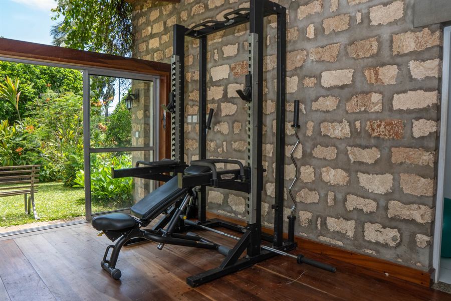 Weights bench and rack against the coral stone wall