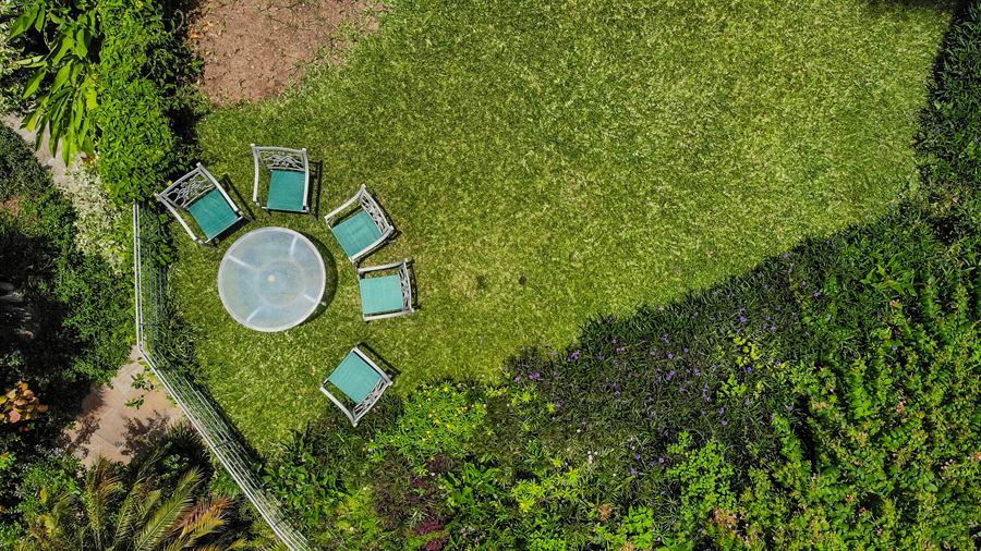 A round table and chairs on the lawn, seen from above