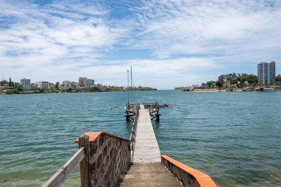 Steps down to the wooden jetty, leading out into the creek