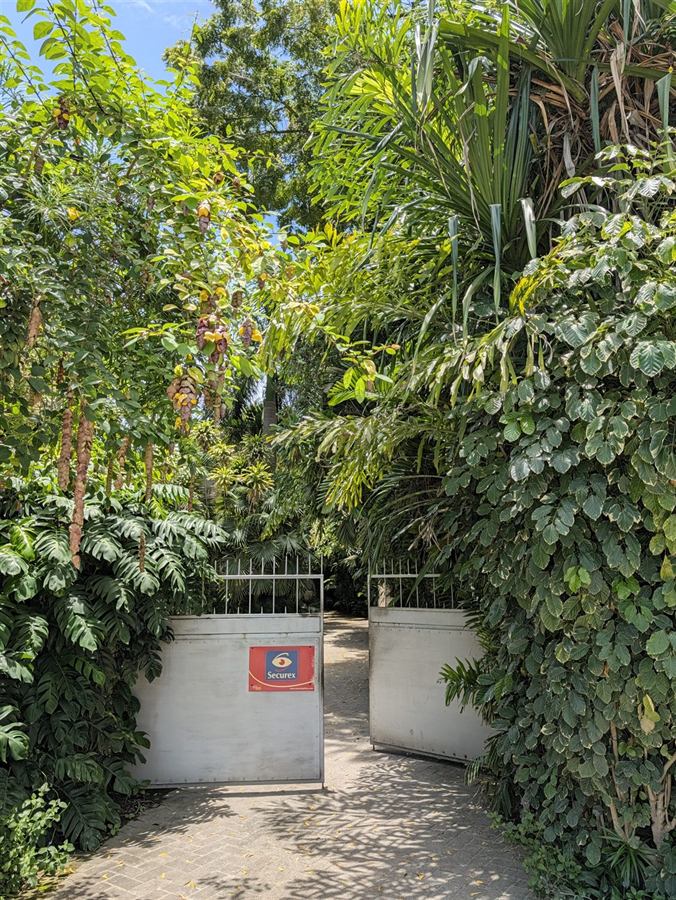 The entrance gate, surrounded by greenery